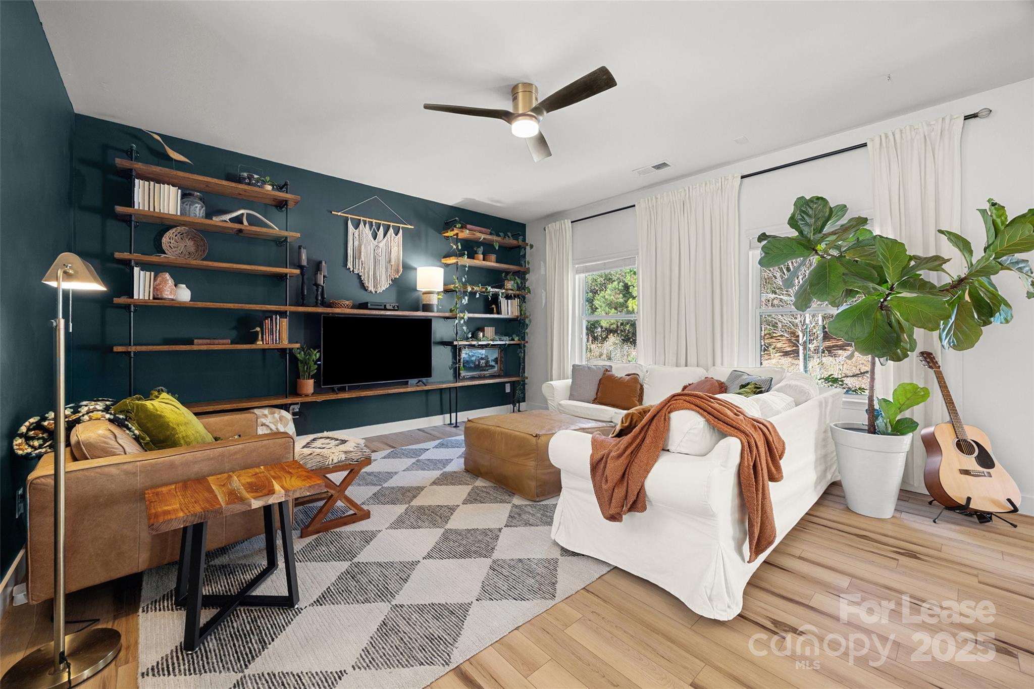 1668 Beleek Ridge Lane Clover, SC 29710 - Photo 5 of 42 a bedroom with a bed a couch and a potted plant