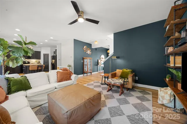 a living room with furniture a rug and a potted plant