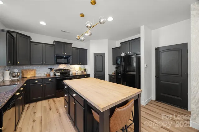 a kitchen with a stove a refrigerator and a sink