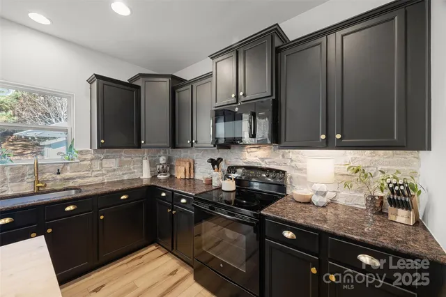 a kitchen with granite countertop a sink and cabinets