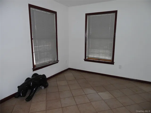 a view of a room that has a bed and a mirror in it