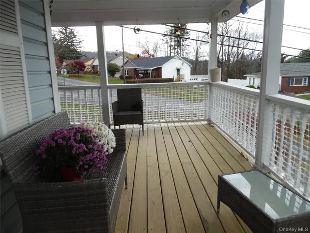 a view of a balcony with wooden floor