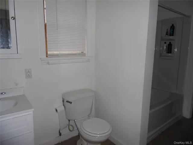 a white toilet sitting next to a bathroom sink