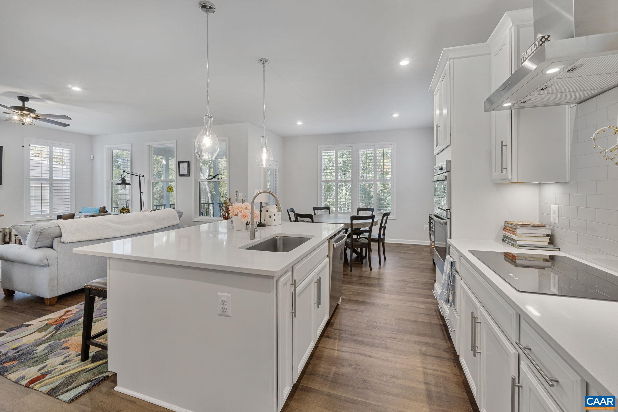 2879 Rambling Brook Lane Crozet, VA 22932 - Photo 13 of 63 a kitchen with counter top space a sink a stove and a chandelier
