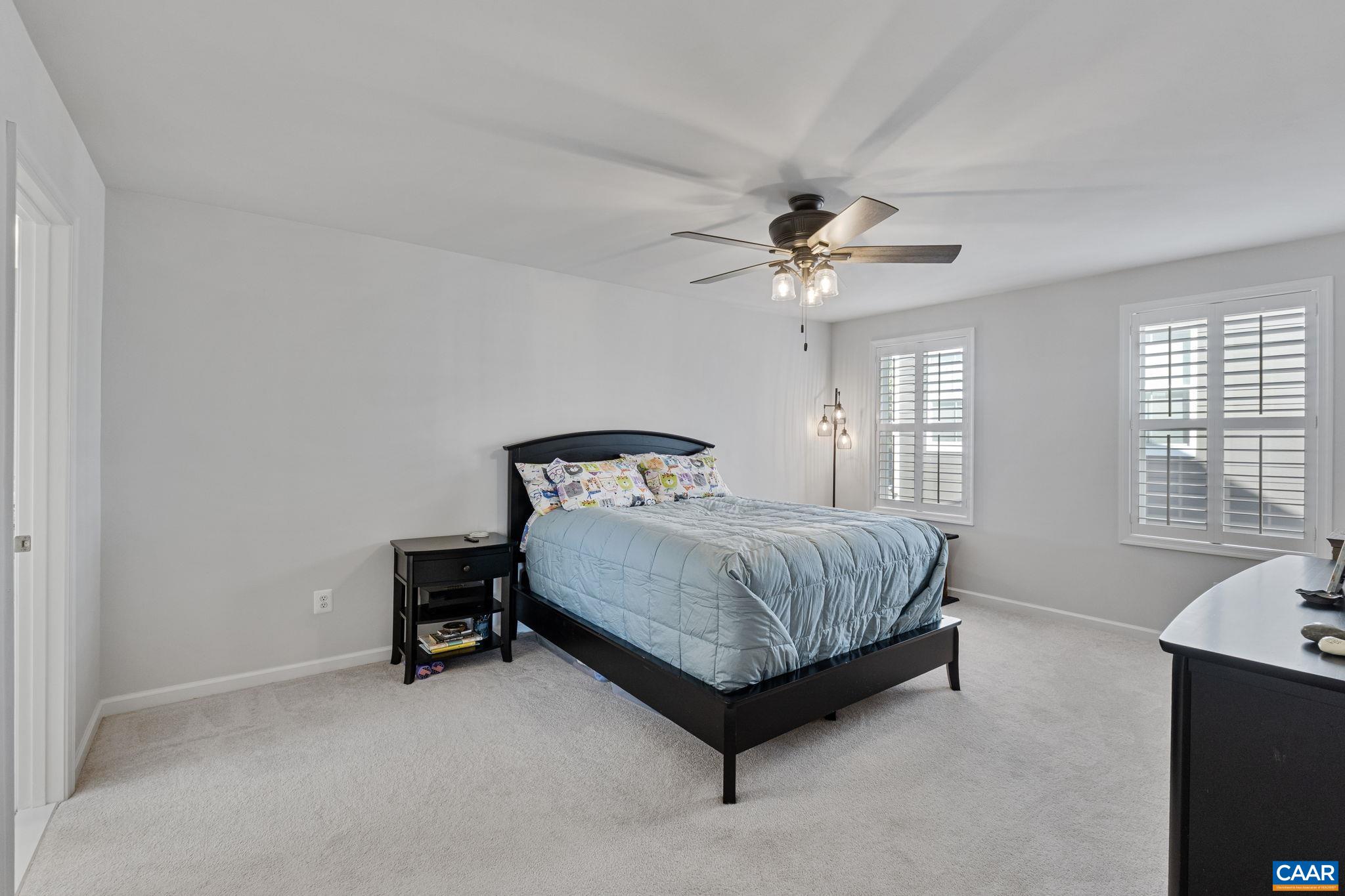 2879 Rambling Brook Lane Crozet, VA 22932 - Photo 24 of 63 a bedroom with a bed and a ceiling fan in it