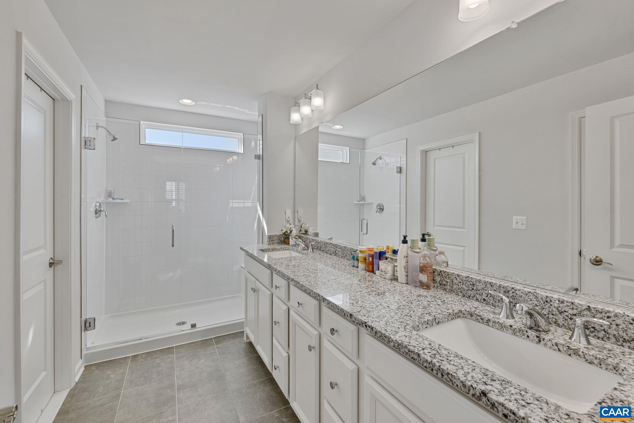 2879 Rambling Brook Lane Crozet, VA 22932 - Photo 26 of 63 a bathroom with double vanity sinks and a shower