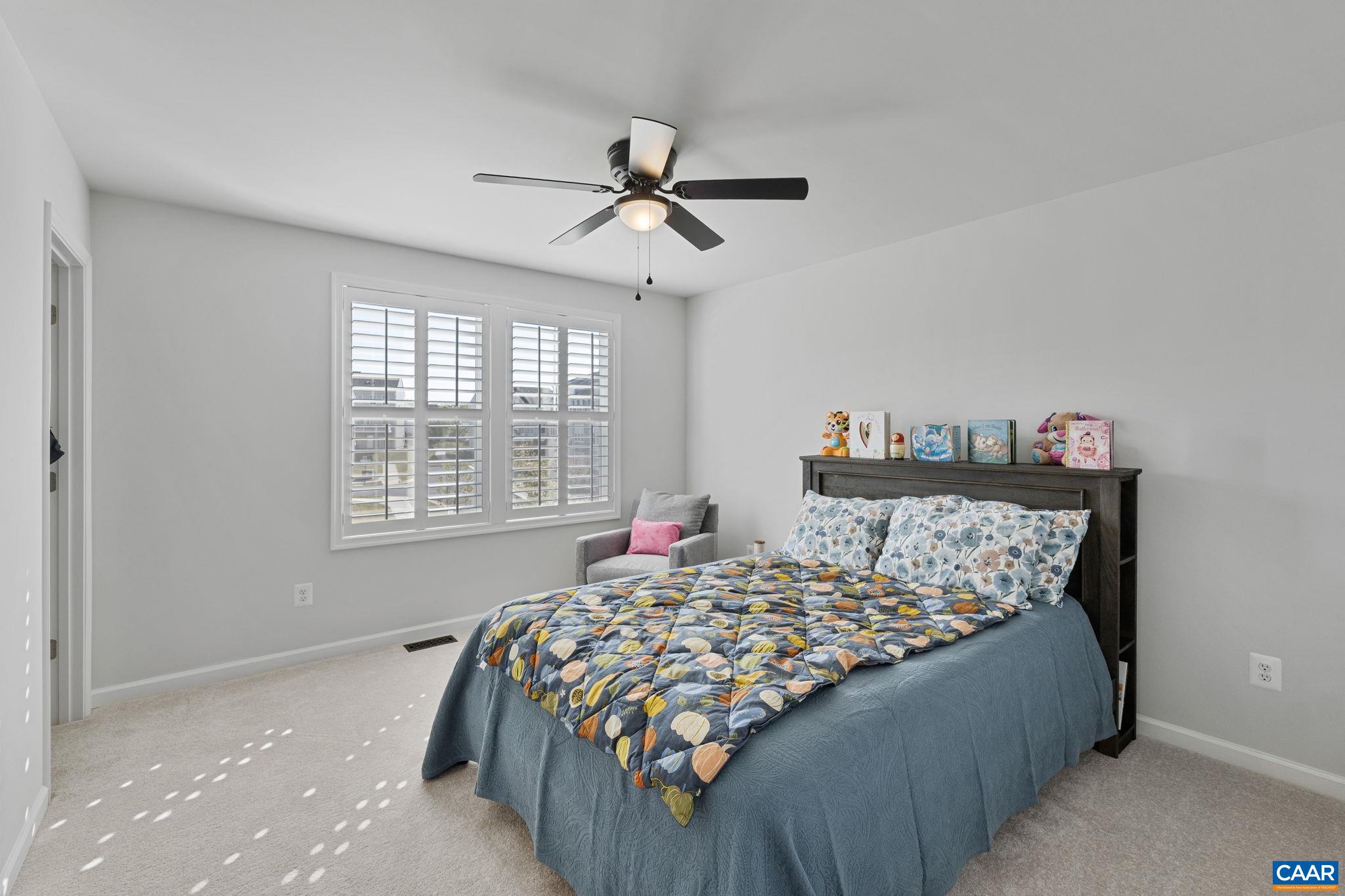 2879 Rambling Brook Lane Crozet, VA 22932 - Photo 30 of 63 a bed sitting in a bedroom next to a window