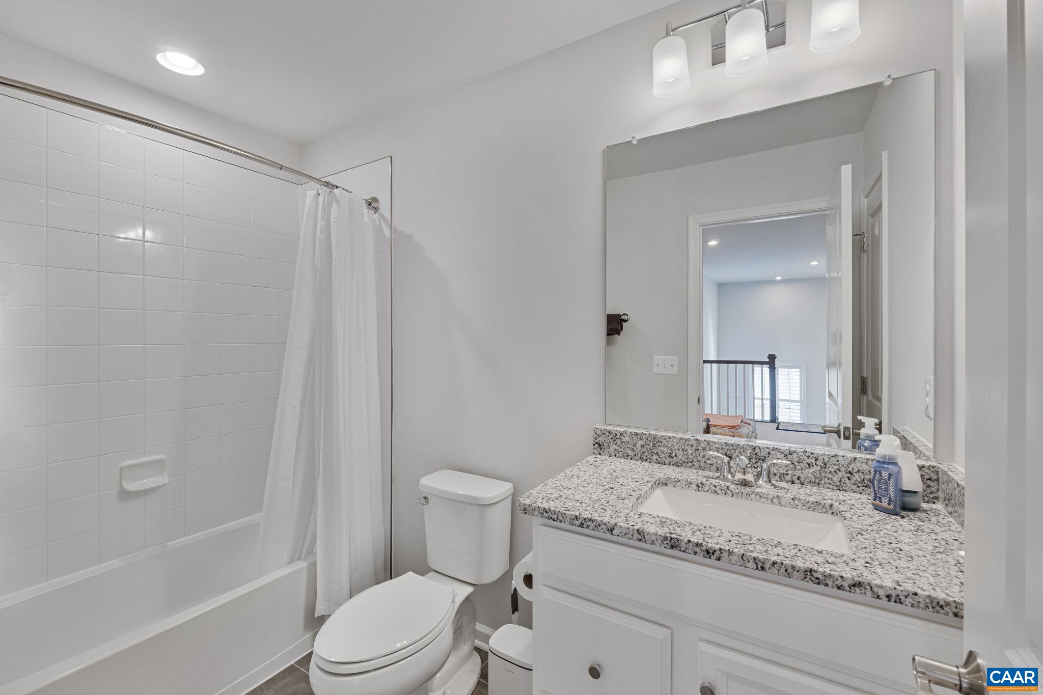 2879 Rambling Brook Lane Crozet, VA 22932 - Photo 31 of 63 a bathroom with a granite countertop sink toilet and shower