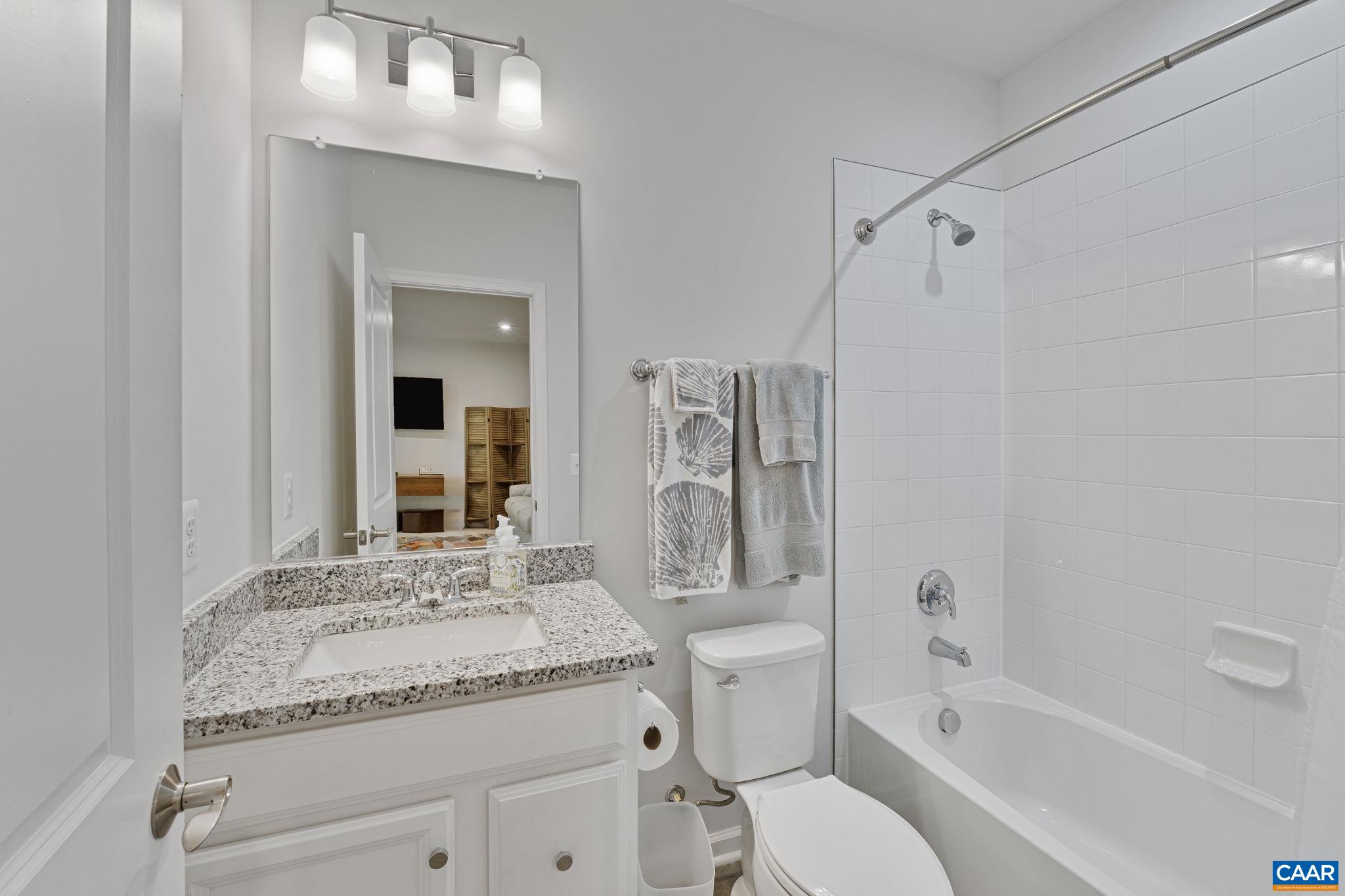 2879 Rambling Brook Lane Crozet, VA 22932 - Photo 36 of 63 a bathroom with a granite countertop sink toilet and shower