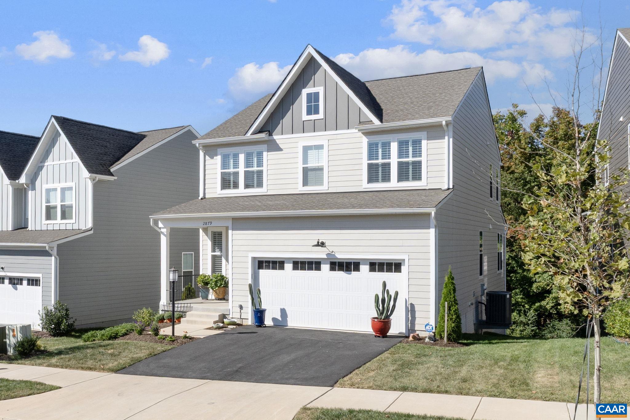 2879 Rambling Brook Lane Crozet, VA 22932 - Photo 4 of 63 a front view of a house with a yard and garage