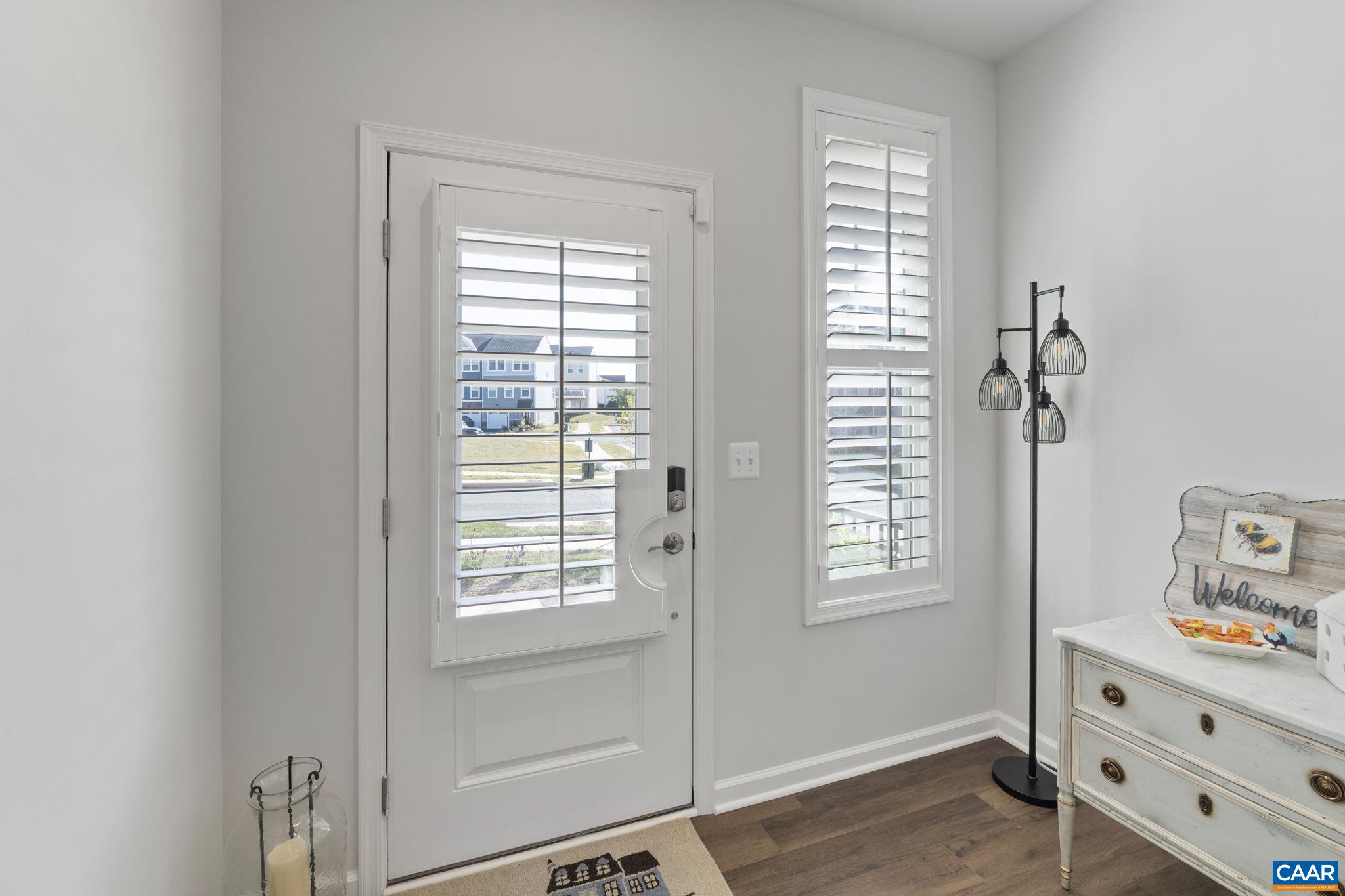 2879 Rambling Brook Lane Crozet, VA 22932 - Photo 7 of 63 a view of an entryway with wooden floor and cabinet