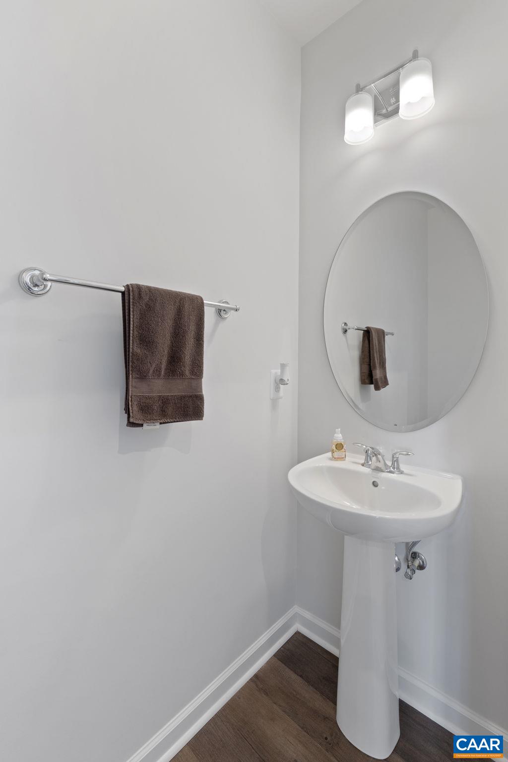 2879 Rambling Brook Lane Crozet, VA 22932 - Photo 8 of 63 a bathroom with a sink a mirror and wooden floor