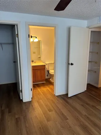 an empty room with wooden floor and a fireplace
