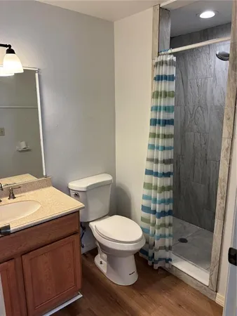 a bathroom with a sink toilet and shower