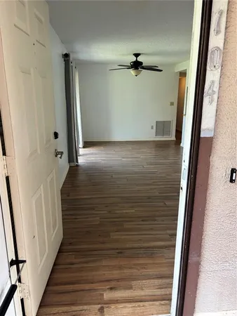 a view of a room with wooden floor and staircase