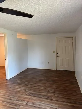 a view of a room with wooden floor and white walls