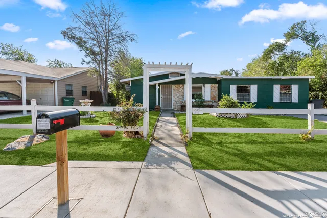 a front view of house with yard and green space