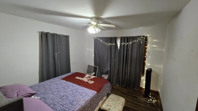 a bedroom with a bed and a mirror