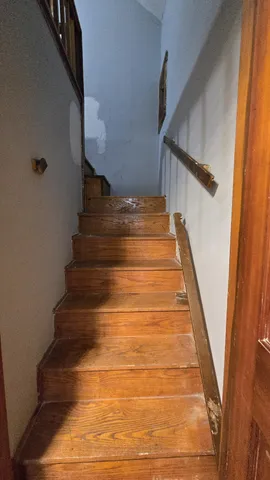 a view of a room with wooden floor and a window