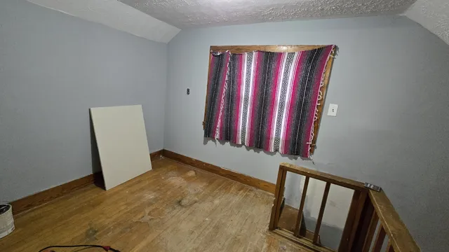 a view of a small house with a yard