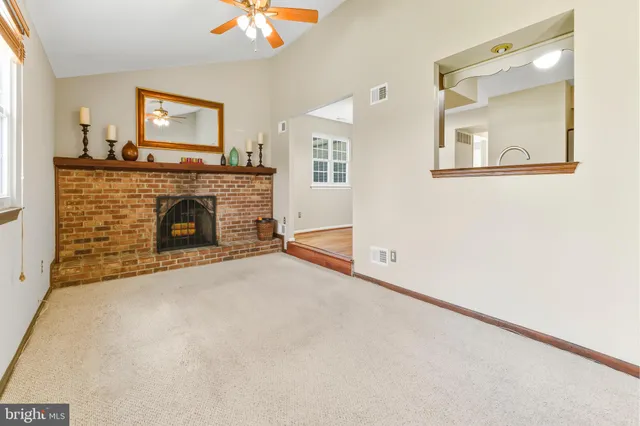 a view of a livingroom with an empty space and a fireplace
