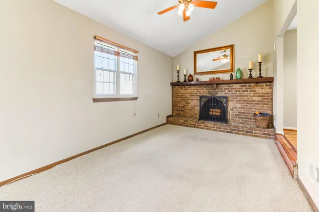 a view of empty room with a fireplace