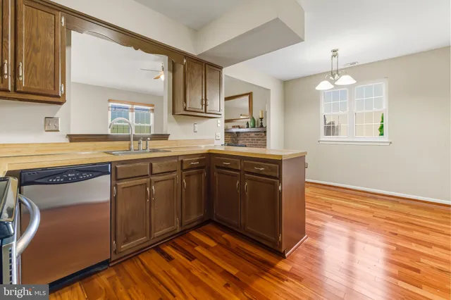 a kitchen with a sink cabinets and wooden floor