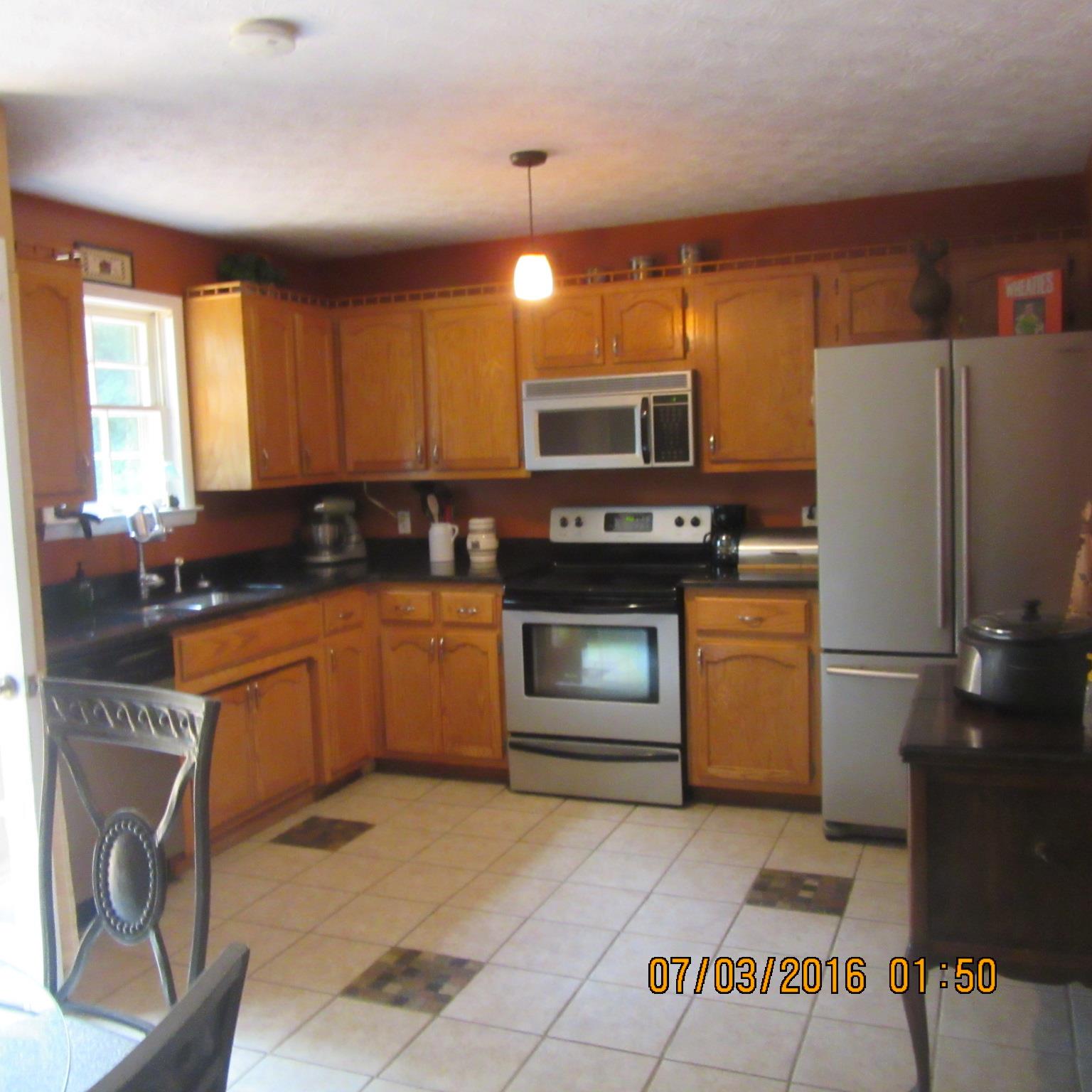 326 Toad Road Dowelltown, TN 37059 - Photo 6 of 17 a kitchen with a refrigerator sink and stove