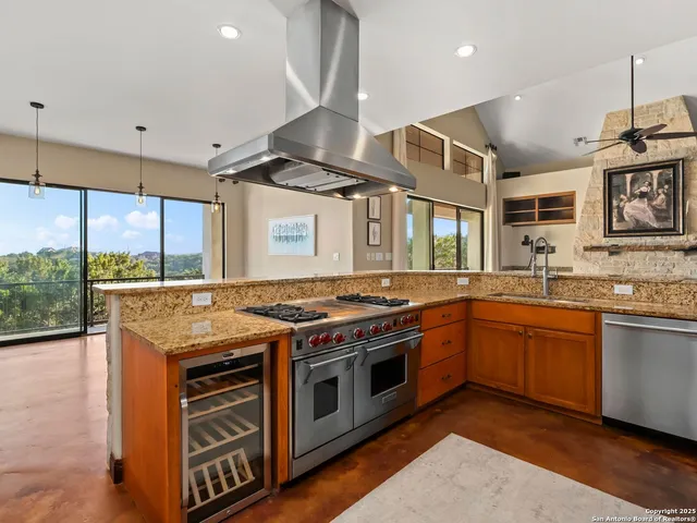 a kitchen with stainless steel appliances granite countertop a stove and a sink
