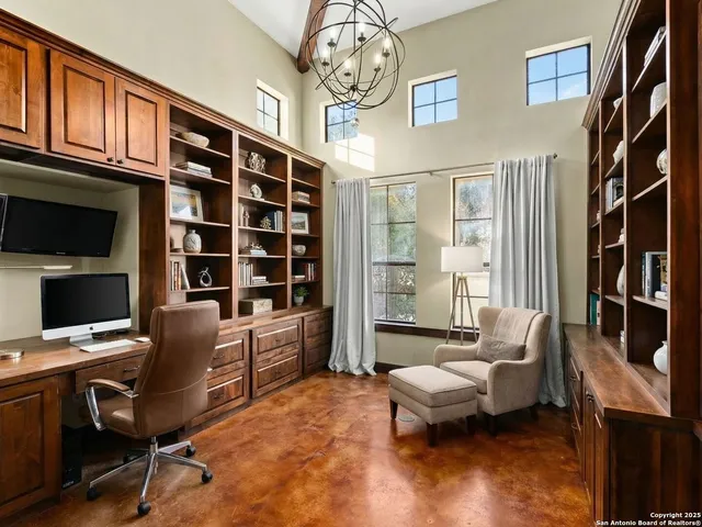 a livingroom with workspace couch and a window