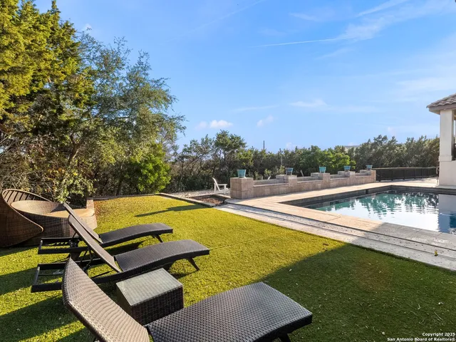 a view of a swimming pool with lounge chairs