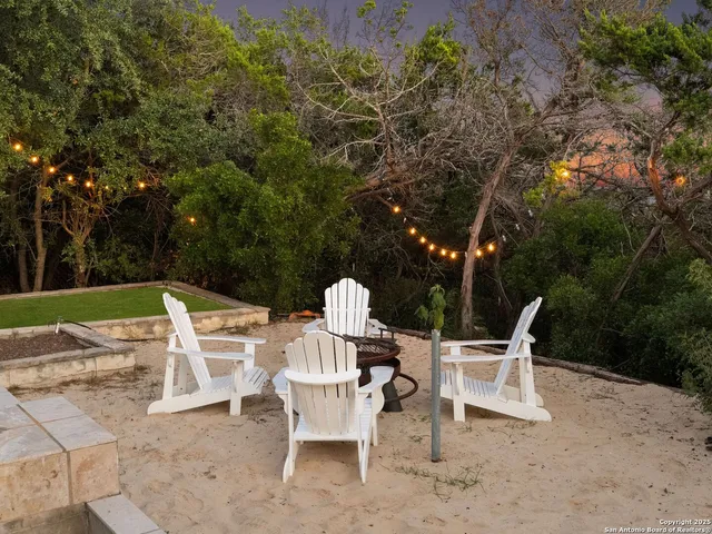 a view of a chairs and table in backyard