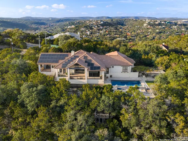 an aerial view of a house with a yard