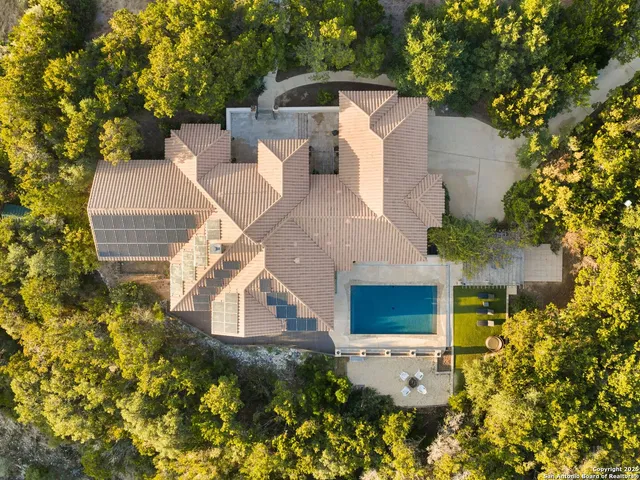an aerial view of a house with a yard