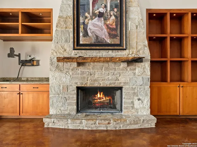 a living room with a fireplace and a rug