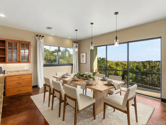 a dining room with furniture a chandelier and wooden floor
