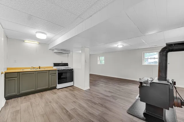 a view of kitchen with sink and refrigerator