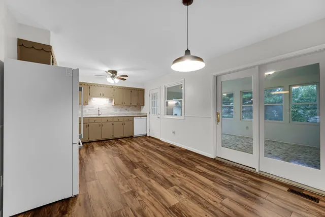 a view of a kitchen with a sink and dishwasher wooden floor