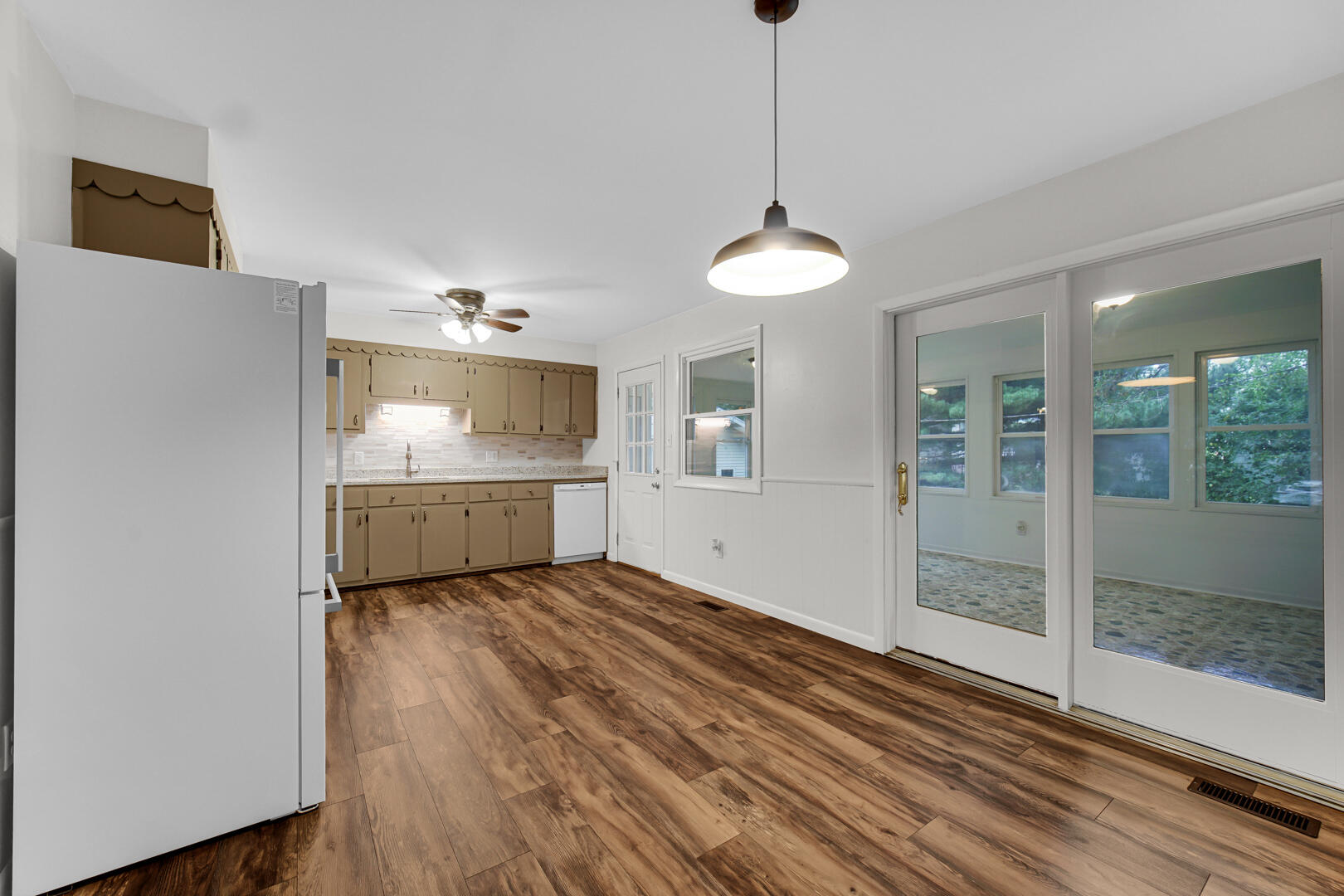 10447 North 477 East Demotte, IN 46310 - Photo 7 of 31 a view of a kitchen with a sink and dishwasher wooden floor