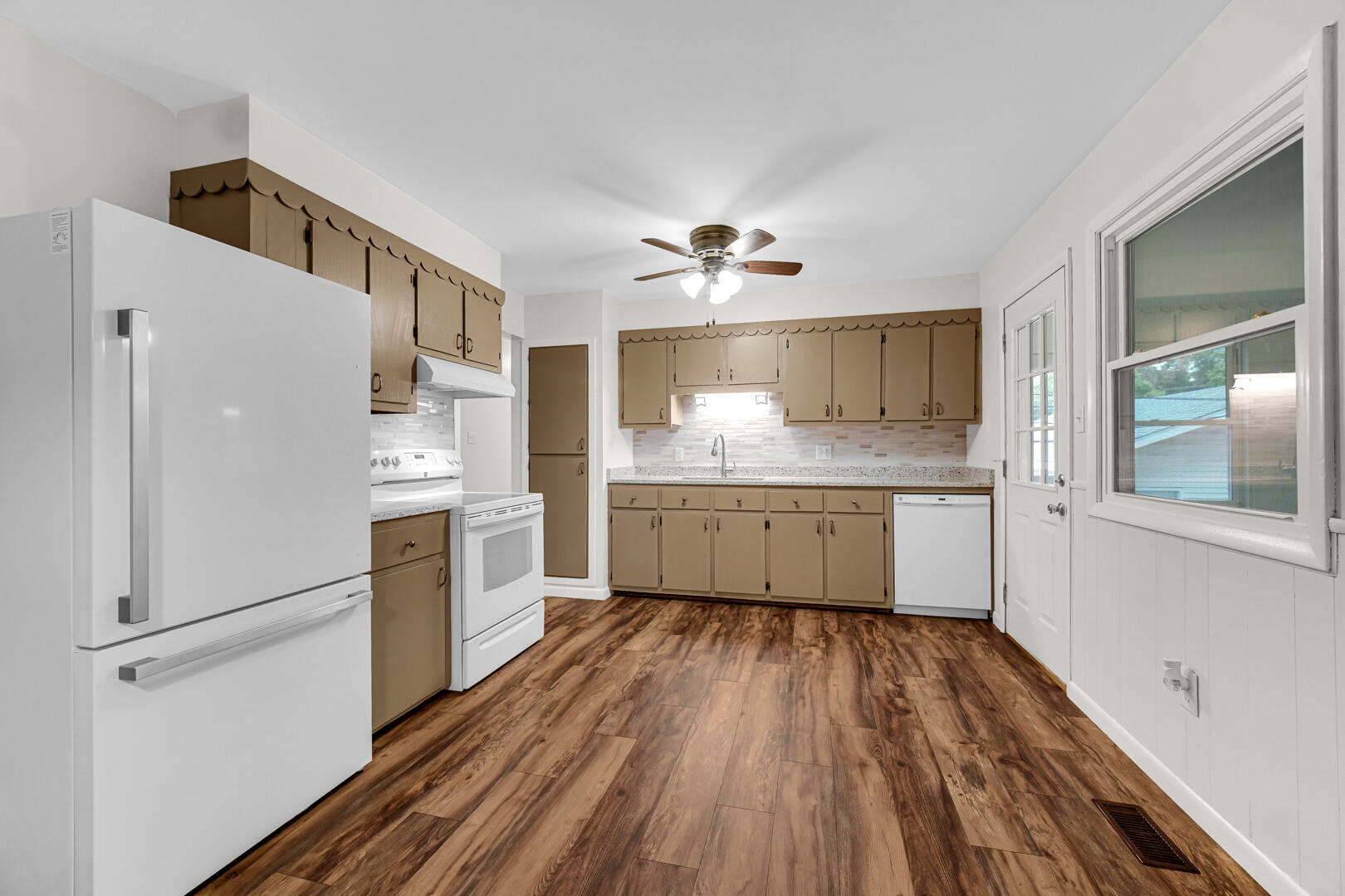 10447 North 477 East Demotte, IN 46310 - Photo 9 of 31 a kitchen with white cabinets and white appliances