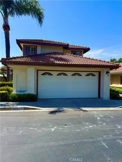 a view of swimming pool with lawn chairs and a fire pit