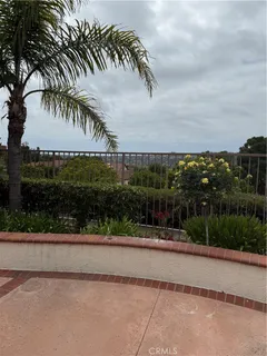 a view of a patio with chairs and plants