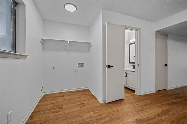 a view of empty room with wooden floor