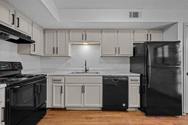 a kitchen with a stove sink and refrigerator