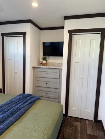 a bedroom with a bed and a flat screen tv