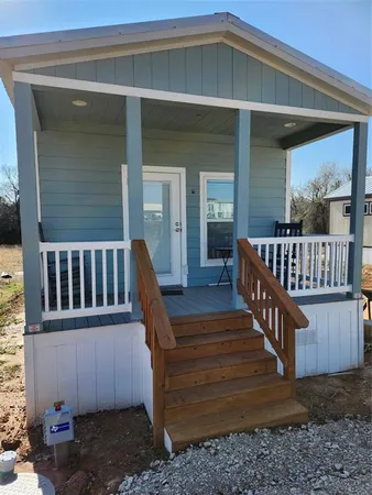 a view of a wooden deck with a yard