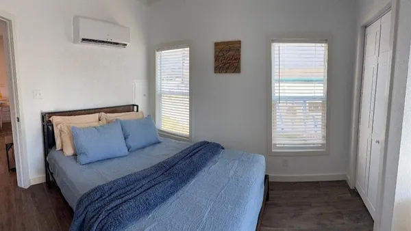 a bedroom with a bed and window