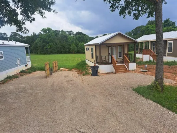 a view of a house with backyard and porch