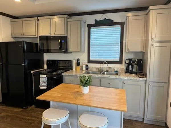 a kitchen with a sink a stove and refrigerator