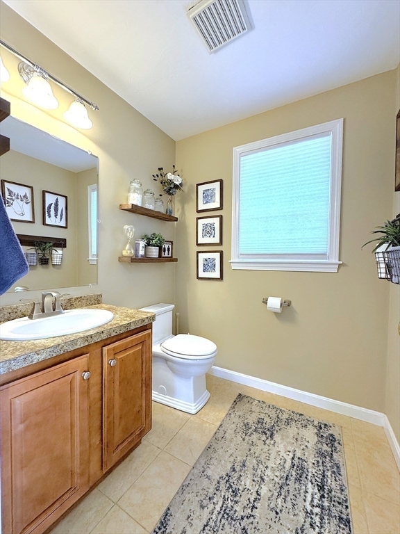 9 Noble Street Dudley, MA 01571 - Photo 11 of 41 a bathroom with a granite countertop toilet sink and mirror